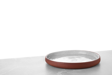 Photo of Empty plate on light table against white background