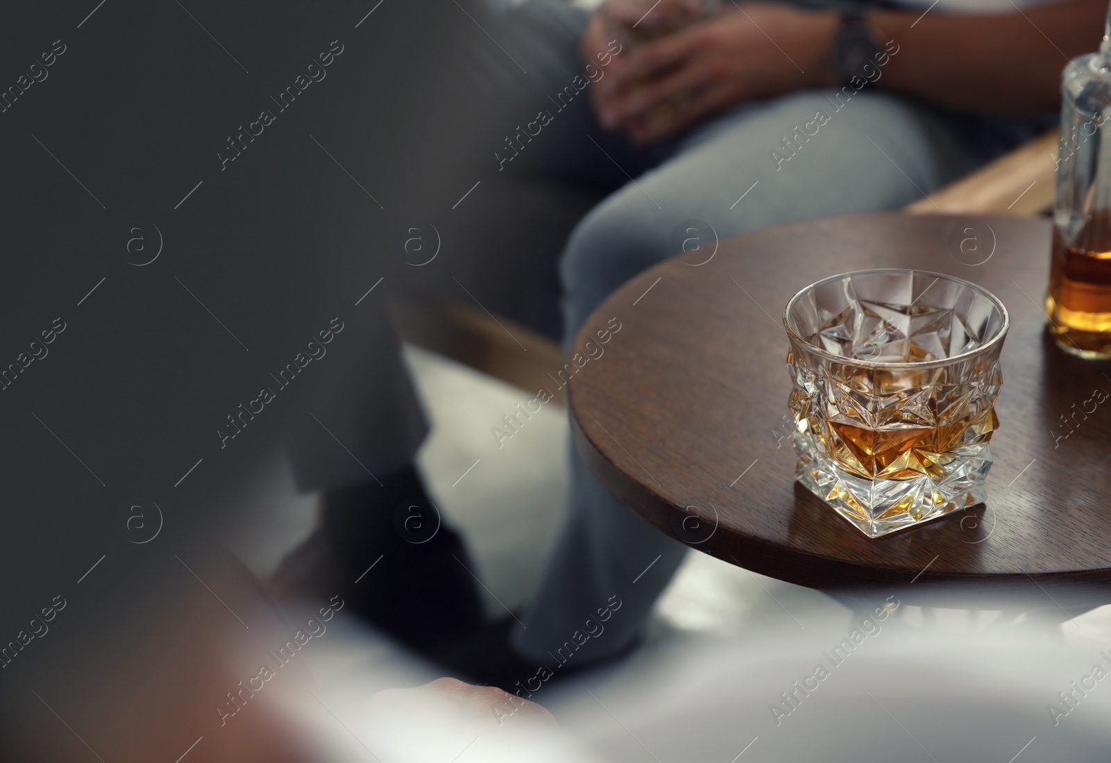 Photo of Glass of whiskey on table in bar. Space for text