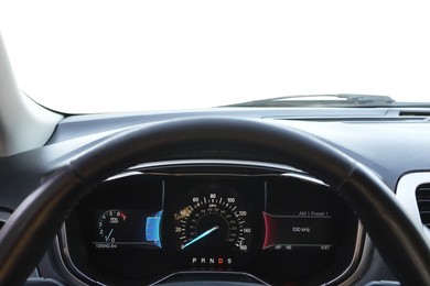 Photo of Speedometer on dashboard and steering wheel inside car