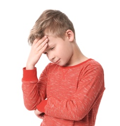 Little boy suffering from headache on white background