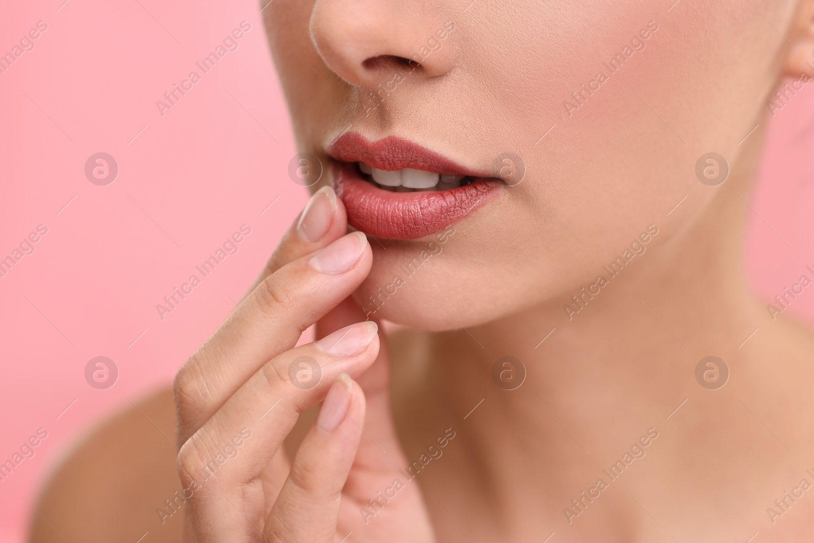 Photo of Woman with beautiful lips on pink background, closeup