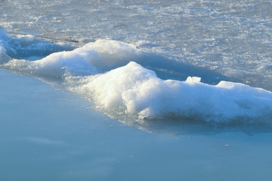 Photo of Melting ice in river water on sunny day. Early spring