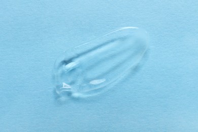 Sample of transparent gel on light blue background, top view