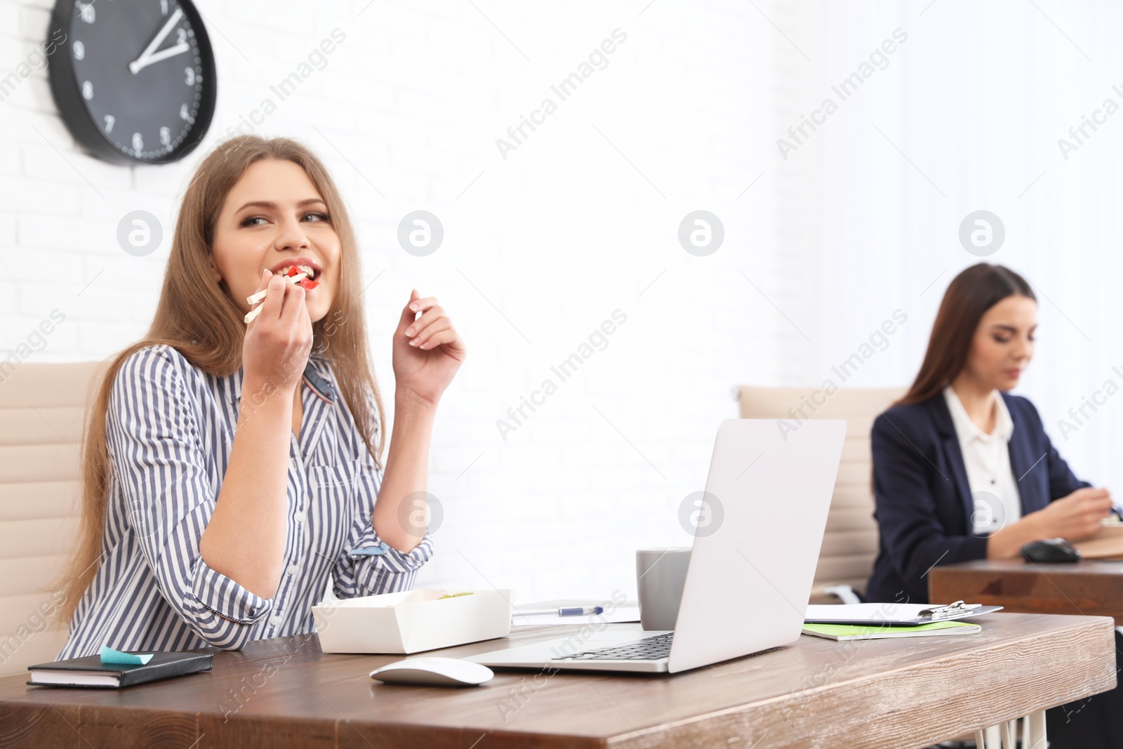 Photo of Office employees having lunch at workplace. Food delivery