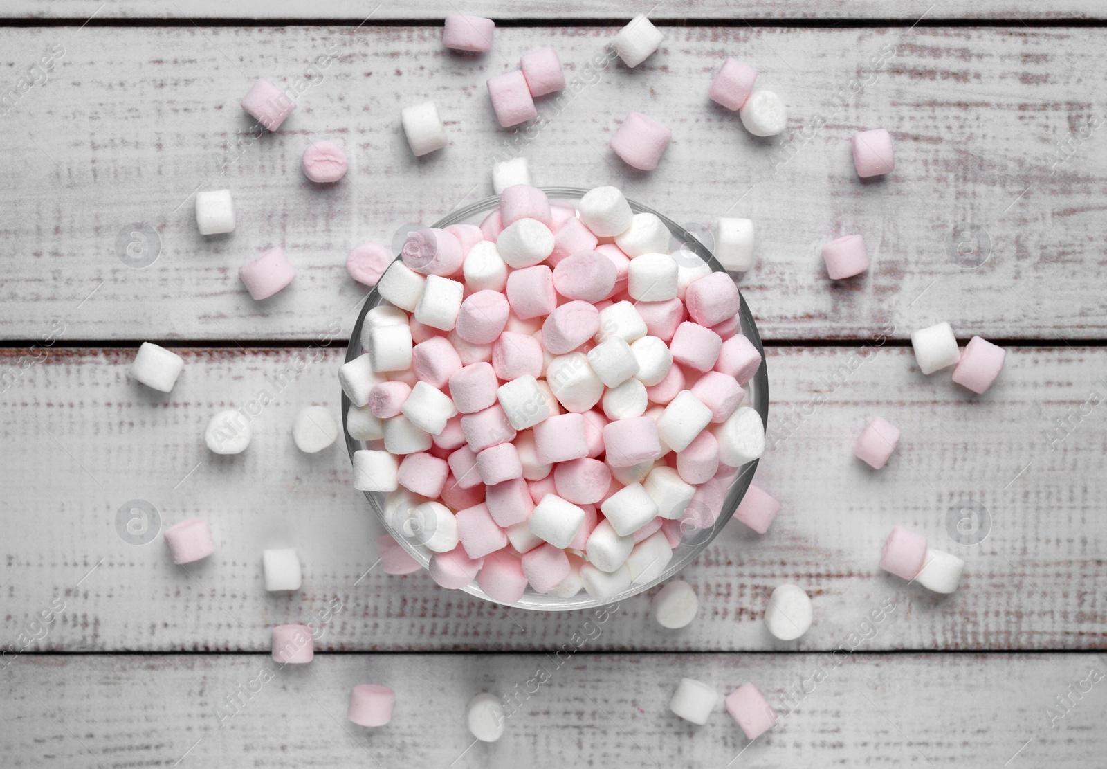 Photo of Delicious marshmallows on wooden table, flat lay