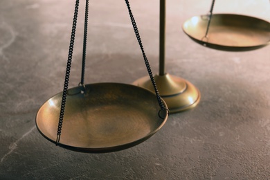 Scales of justice on table, closeup. Law concept