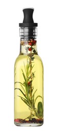 Photo of Glass bottle of cooking oil with spices and herbs isolated on white