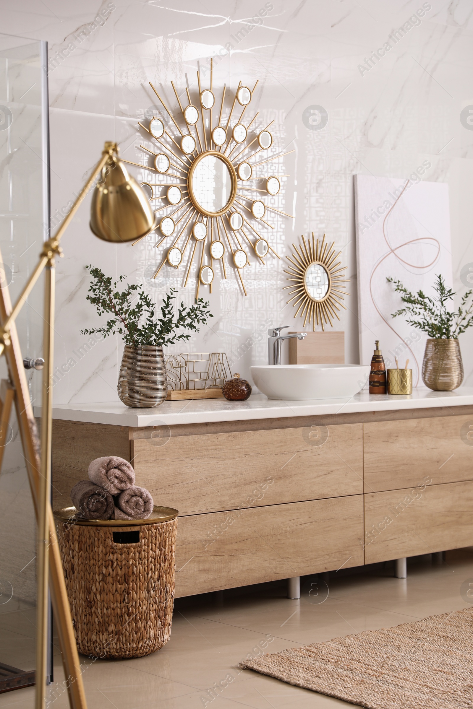 Photo of Modern bathroom interior with stylish mirror, floor lamp and vessel sink