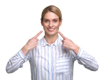 Woman showing her clean teeth and smiling on white background