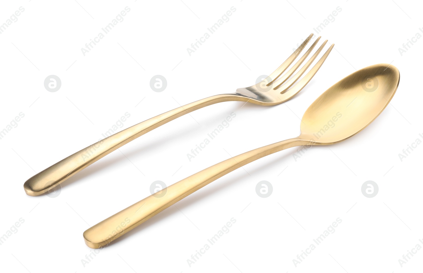 Photo of Shiny golden fork and spoon isolated on white. Luxury cutlery