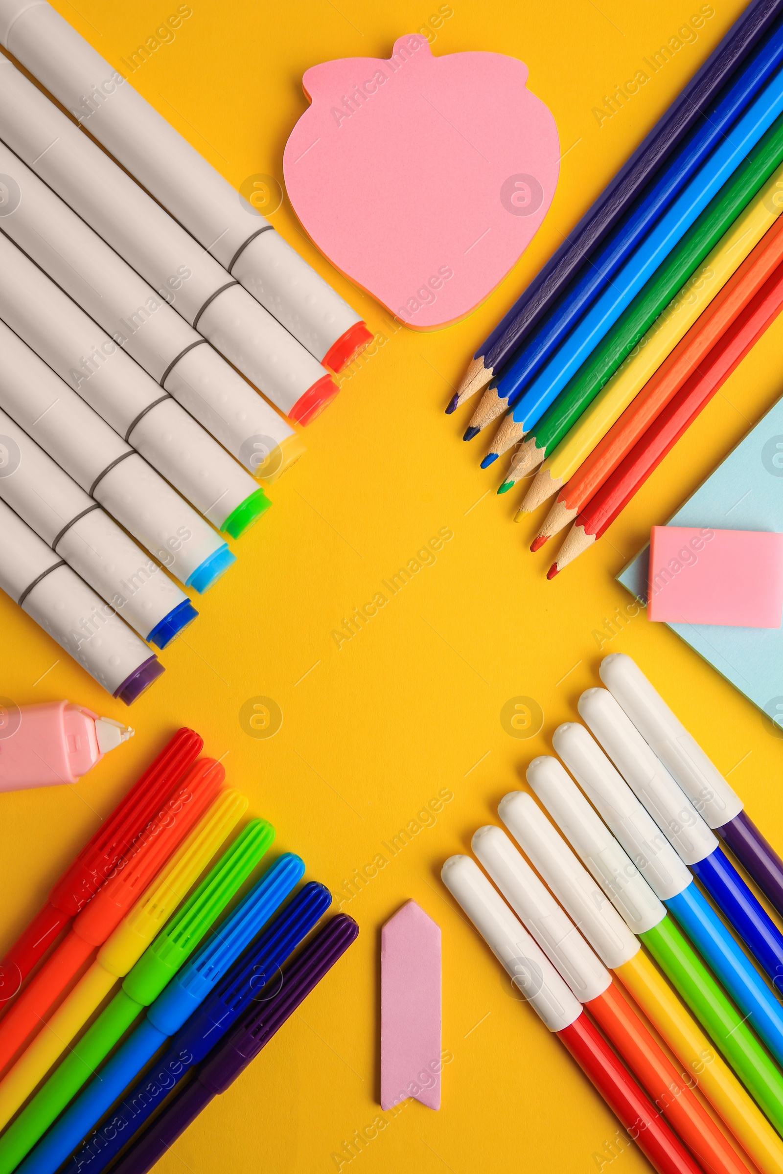 Photo of Frame of different school stationery on yellow background, flat lay with space for text. Back to school