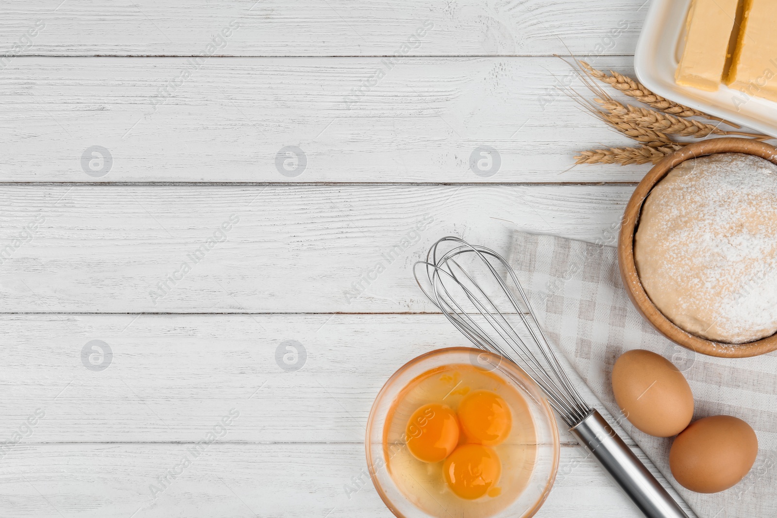 Photo of Flat lay composition with eggs and other ingredients  on white wooden table, space for text. Baking pie