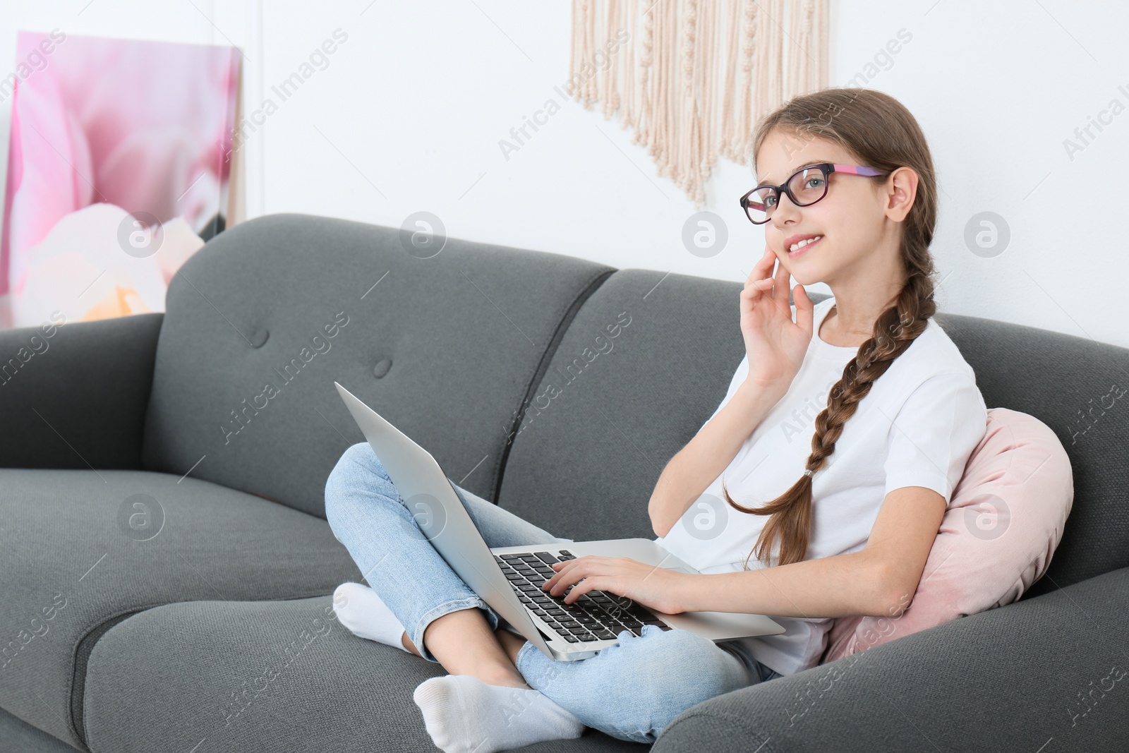 Photo of Girl with laptop on sofa at home