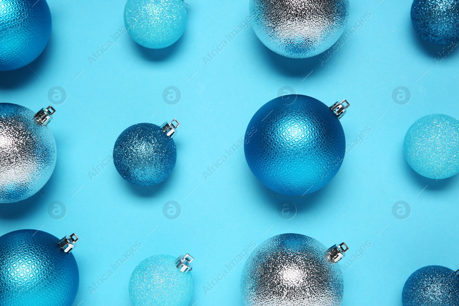 Photo of Christmas balls on light blue background, flat lay