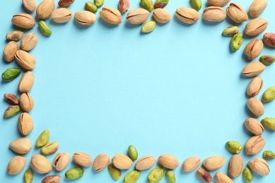 Photo of Frame made of organic pistachio nuts, flat lay. Space for text