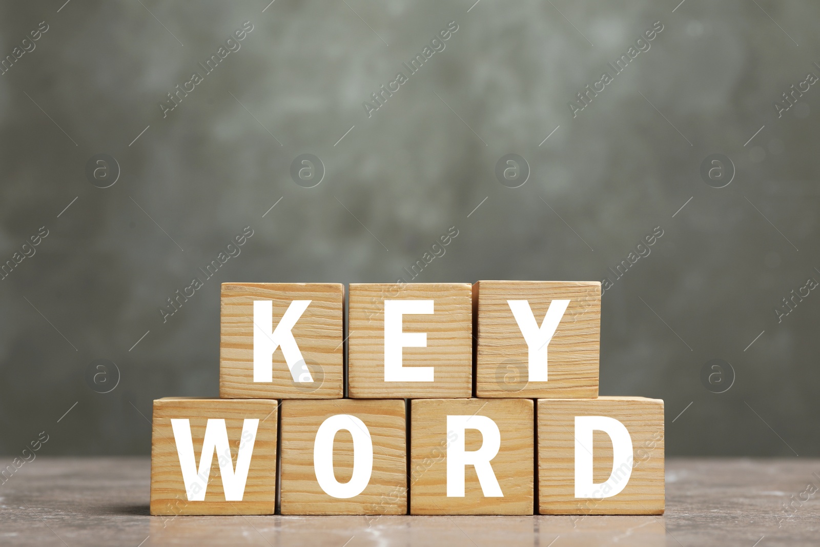 Photo of Word KEYWORD made of wooden cubes on marble table