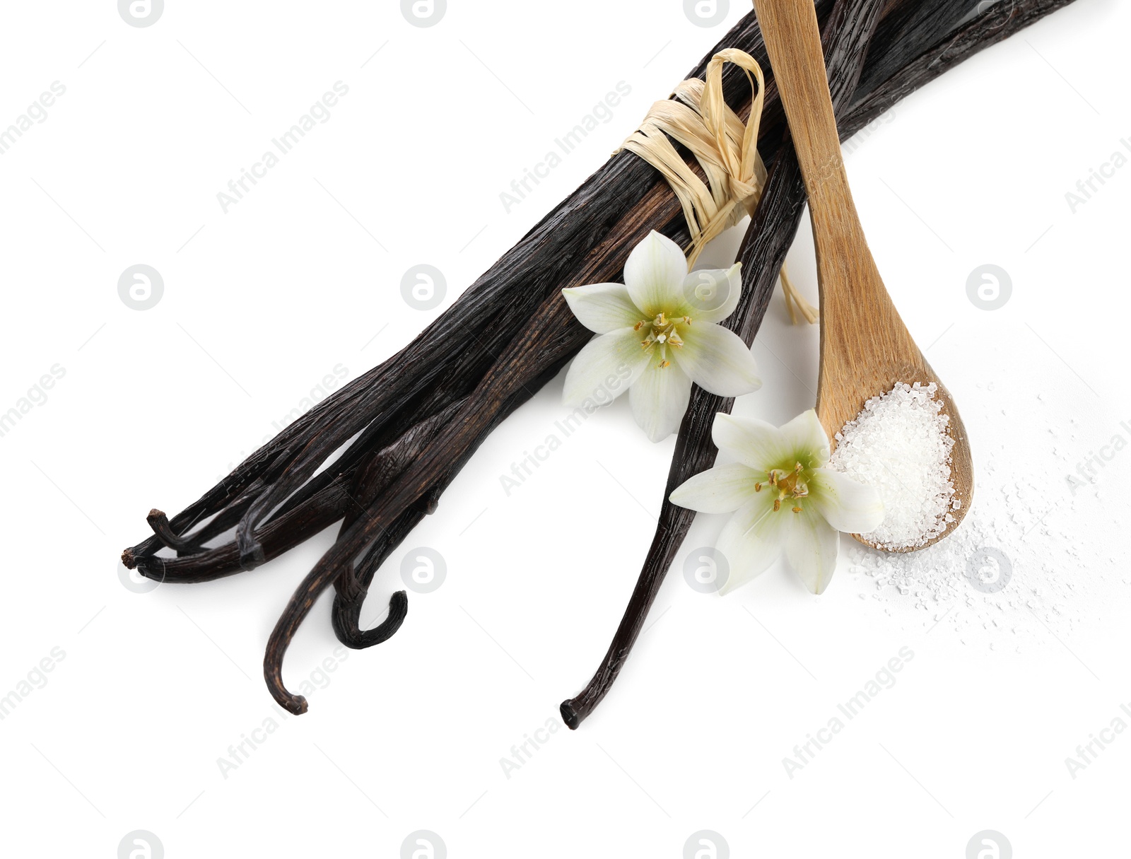 Photo of Vanilla pods, spoon with sugar and flowers isolated on white, top view