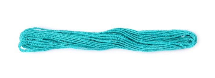 Bright turquoise embroidery thread on white background