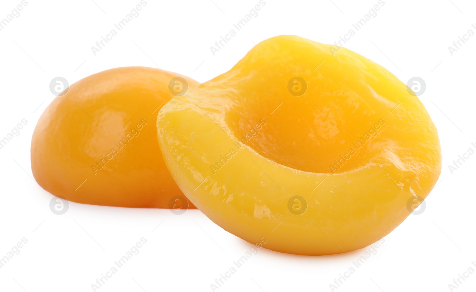 Photo of Sweet juicy canned peach halves isolated on white