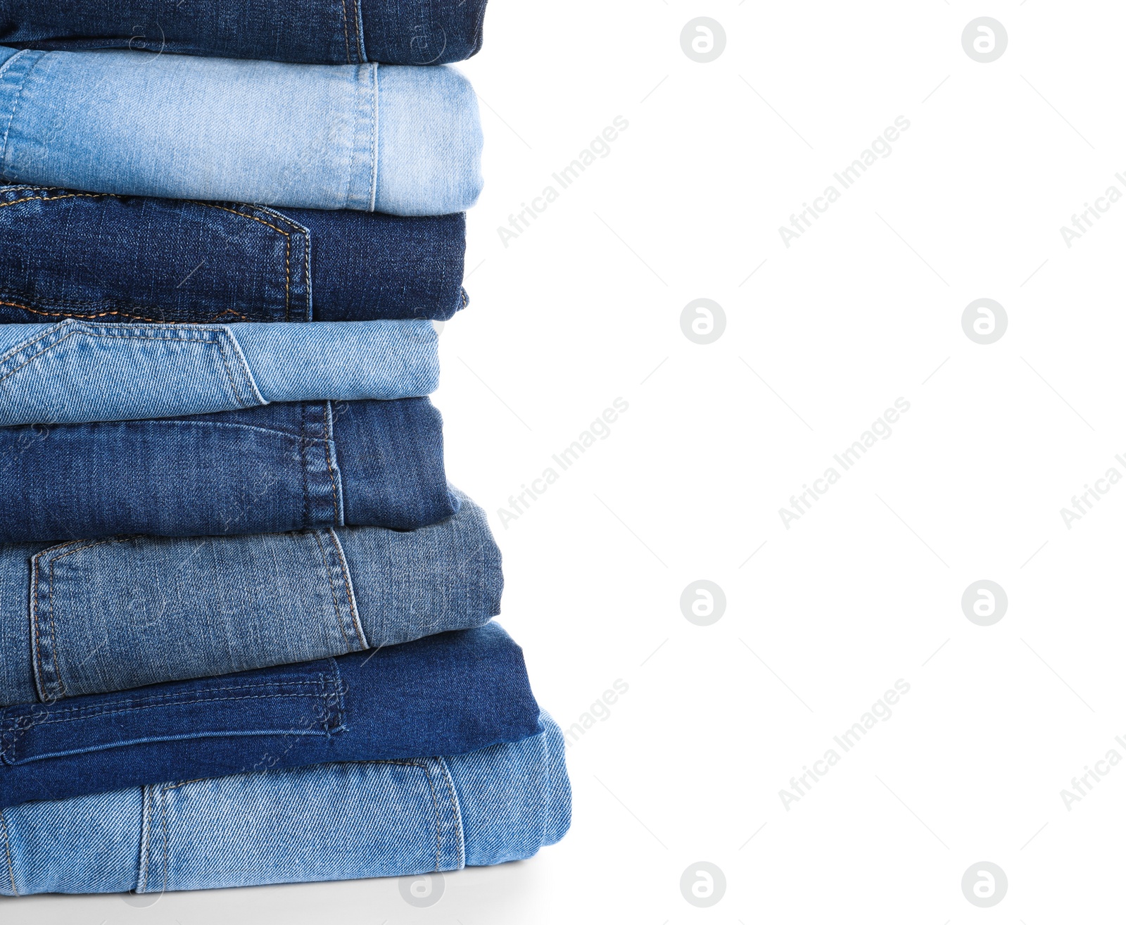 Photo of Stack of different jeans isolated on white