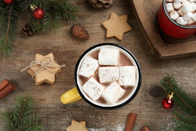 Photo of Flat lay composition with delicious marshmallow cocoa and Christmas decor on wooden table