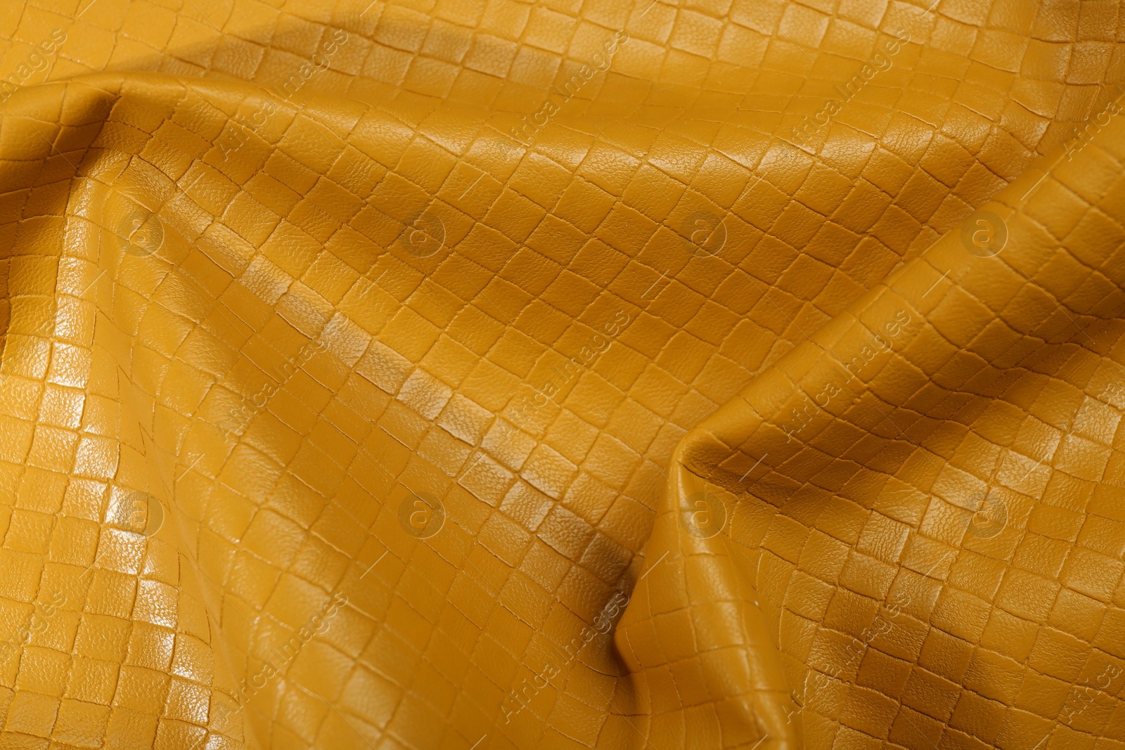 Photo of Beautiful yellow leather as background, top view