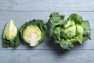 Photo of Flat lay composition with fresh green savoy cabbages on grey wooden table