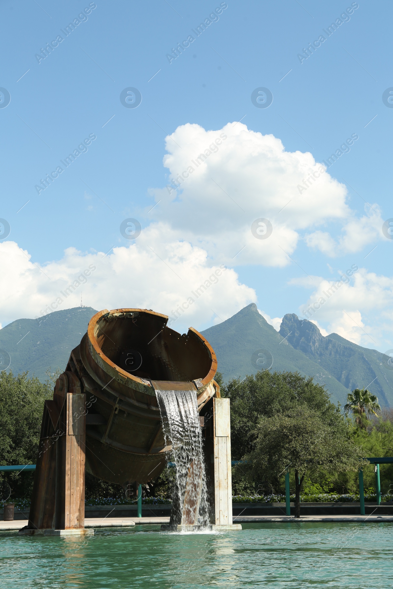 Photo of Monterrey, Mexico - September 11, 2022: Fuente de Crisol (Melting Pot Fountain) and beautiful mountains in Parque Fundidora