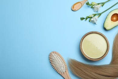 Flat lay composition with homemade hair mask and ingredients on light blue background. Space for text