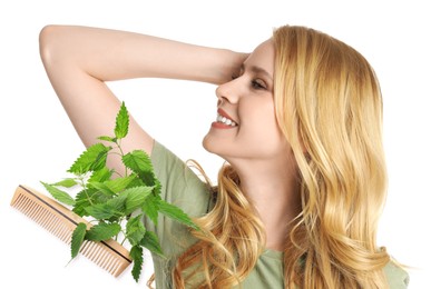 Image of Natural hair care. Beautiful young woman, green stinging nettles and comb on white background