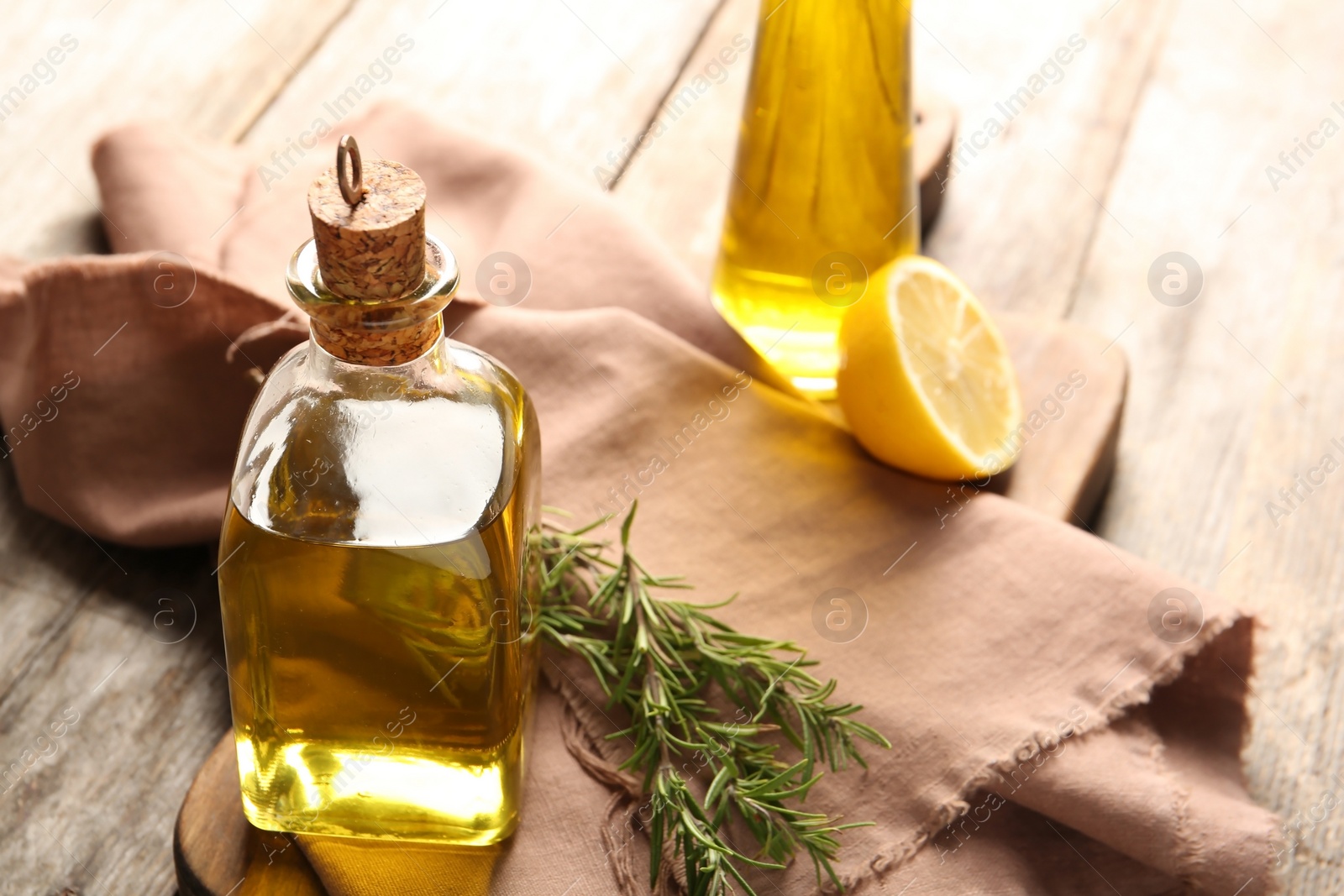 Photo of Composition with bottle of rosemary oil on wooden background