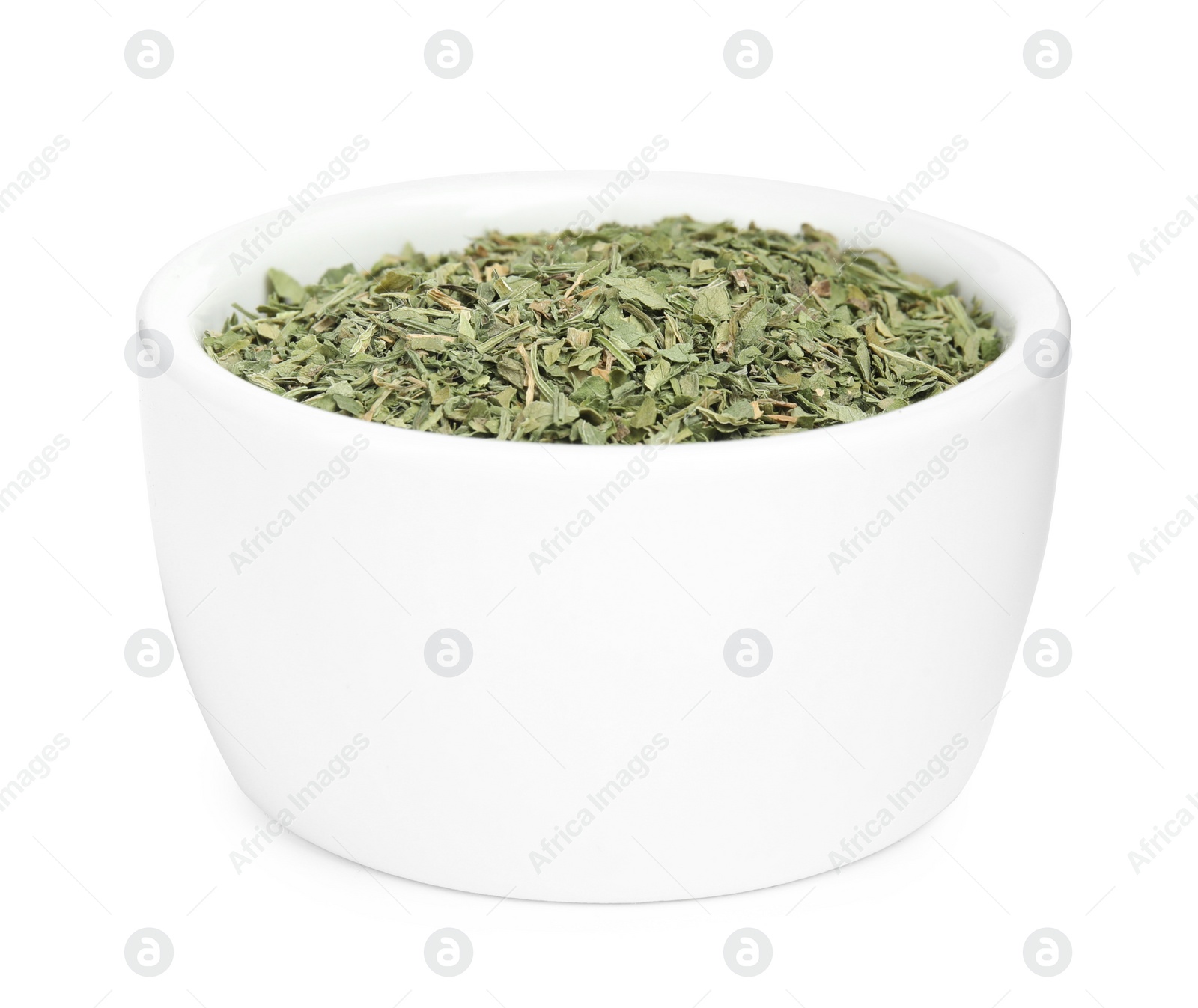 Photo of Bowl with dried parsley on white background