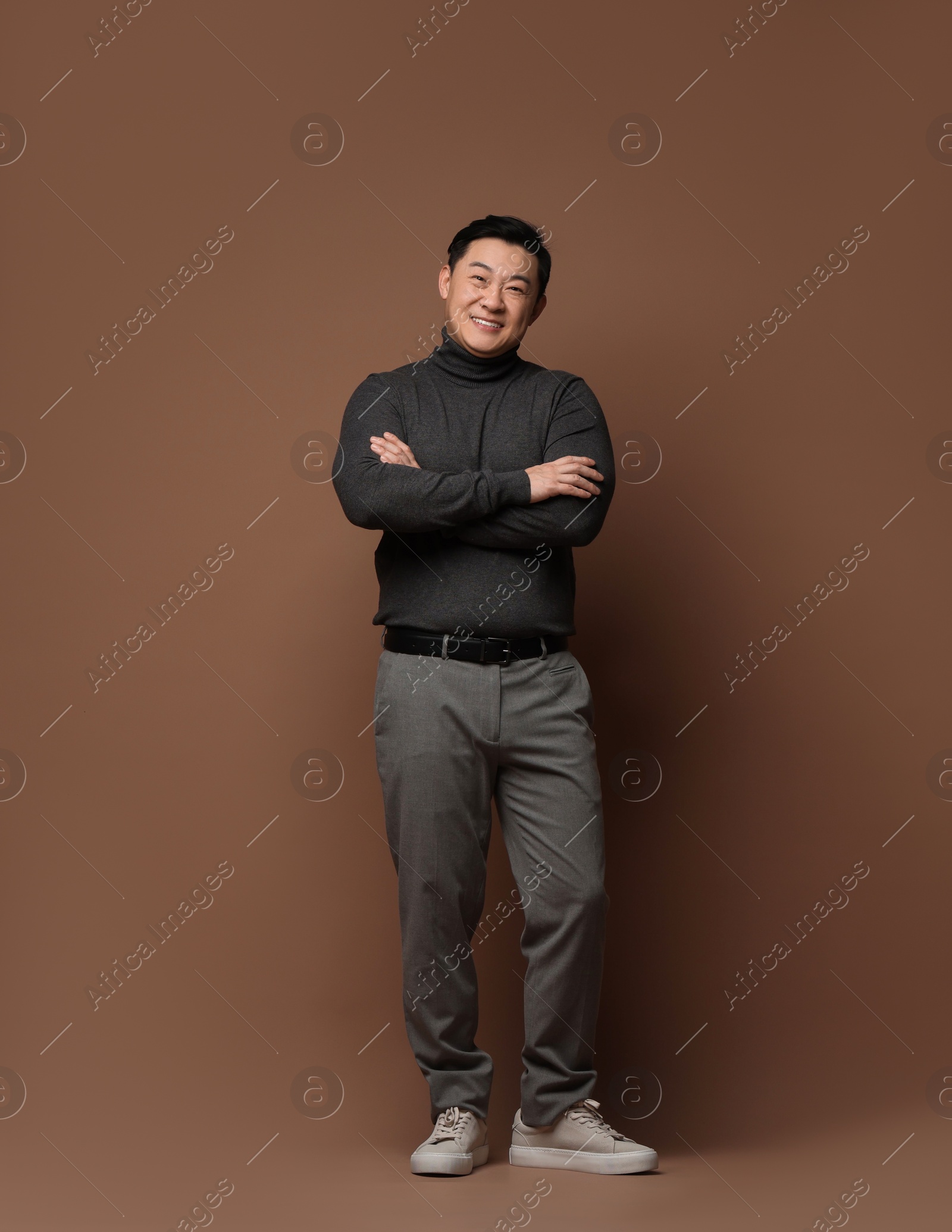 Photo of Full length portrait of happy man on brown background