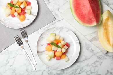 Photo of Salad with watermelon and melon on marble background, flat lay