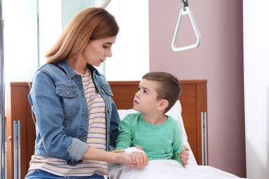 Photo of Woman visiting her little child with intravenous drip in hospital