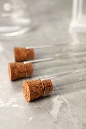 Photo of Test tubes on grey marble table, closeup. Laboratory glassware