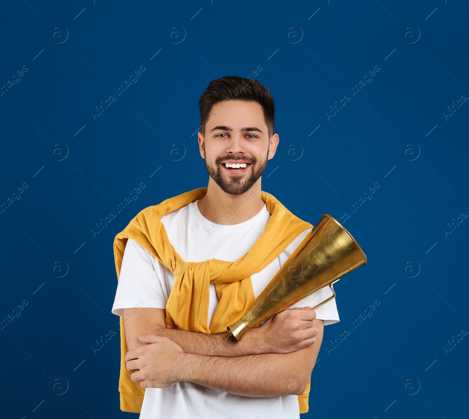 Photo of Young man with megaphone on blue background