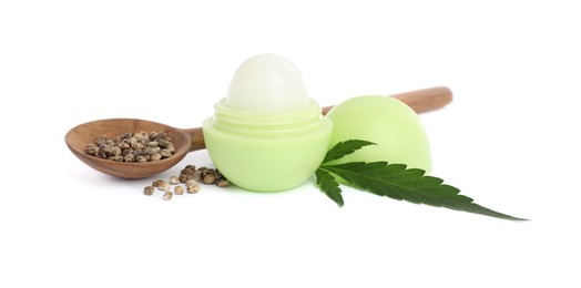 Photo of Hemp lip balm, green leaf and spoon with seeds on white background. Natural cosmetics