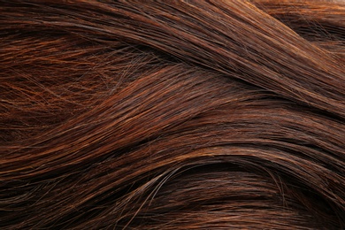 Photo of Texture of healthy brown hair as background, closeup