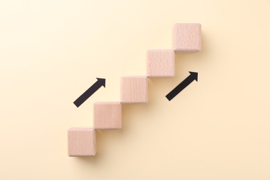 Photo of Business process organization and optimization. Scheme with wooden figures and arrows on beige background, top view