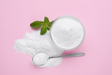 Photo of Sweet powdered fructose and mint leaves on pink background, flat lay