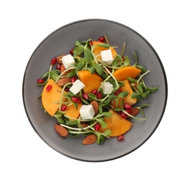 Delicious persimmon salad with feta cheese and pomegranate isolated on white, top view