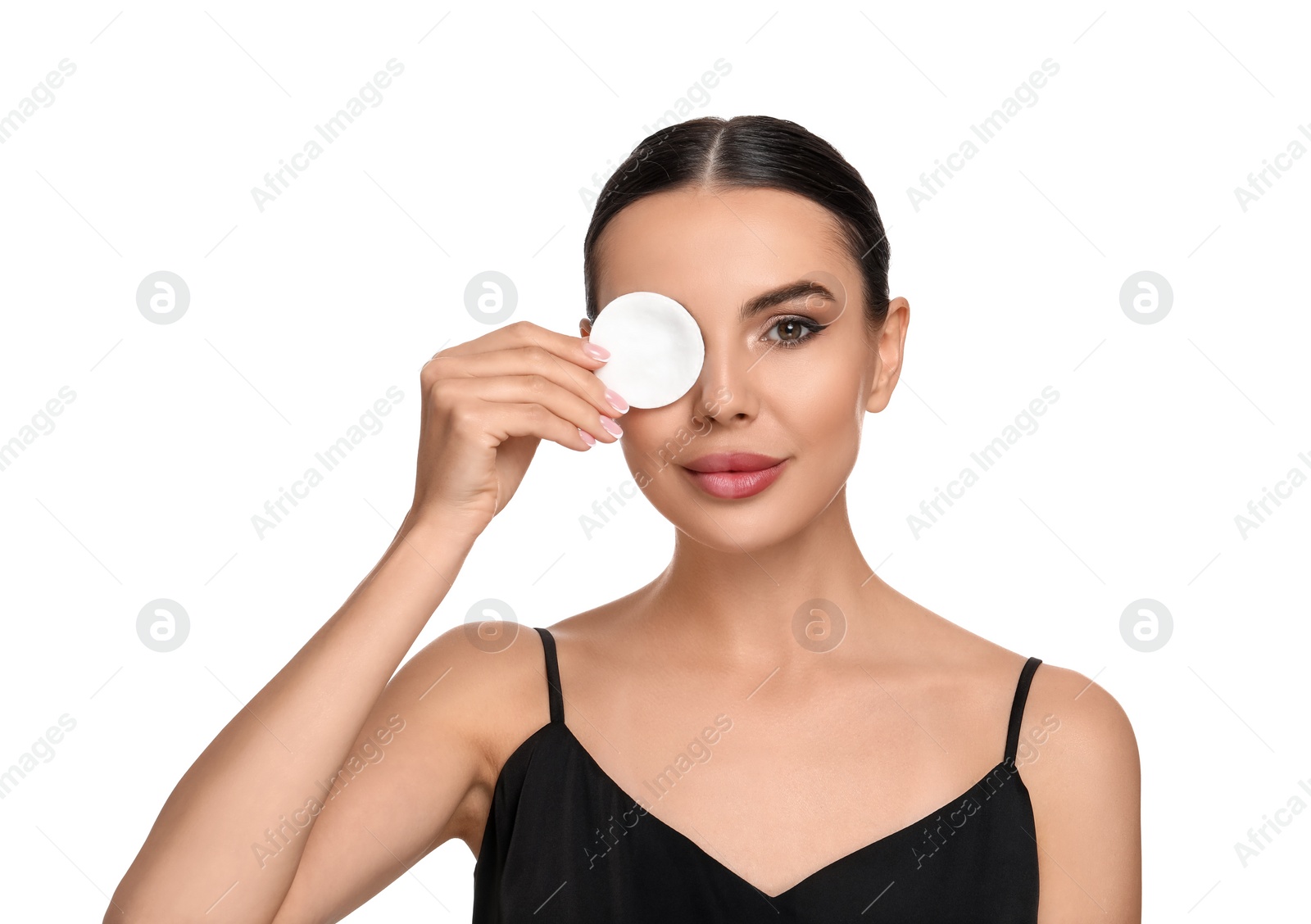 Photo of Beautiful woman removing makeup with cotton pad on white background