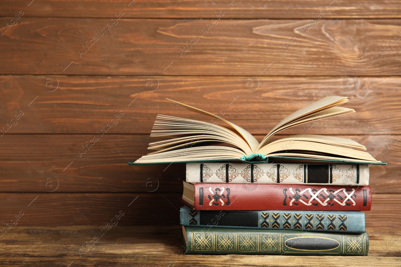 Photo of Collection of old books on wooden shelf