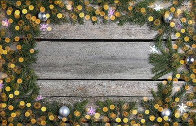 Christmas greeting card with space for text. Flat lay composition of fir tree branches and festive decor on wooden background