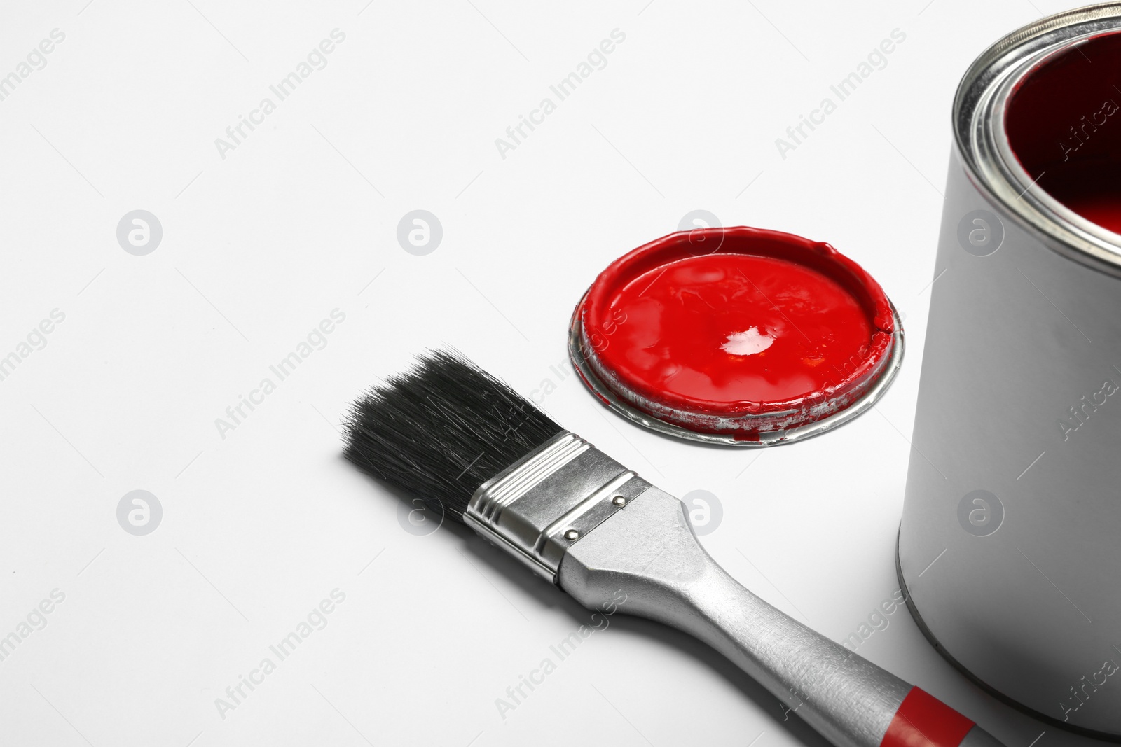 Photo of Paint can and brush on white background, space for text