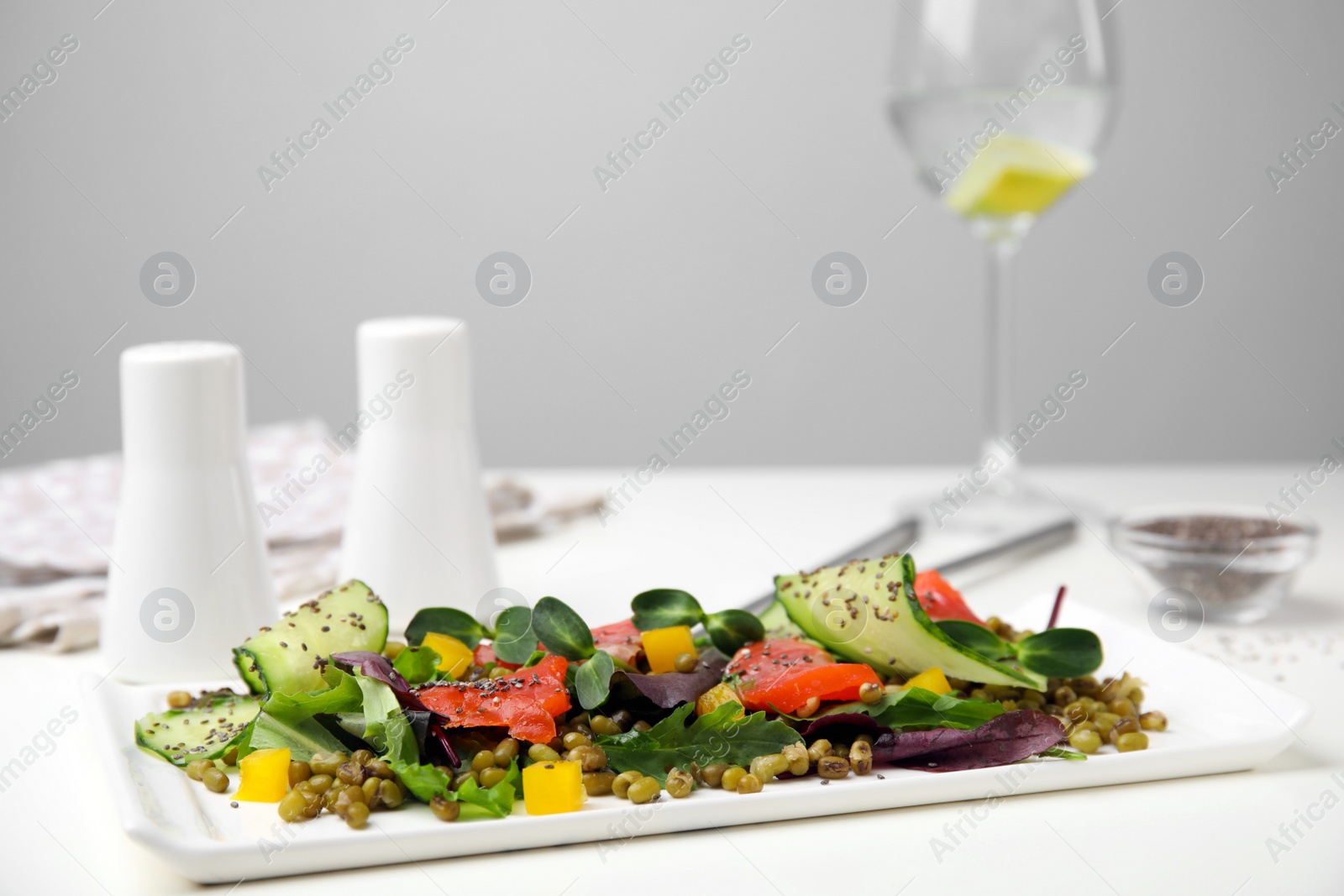 Photo of Plate of salad with mung beans on white table