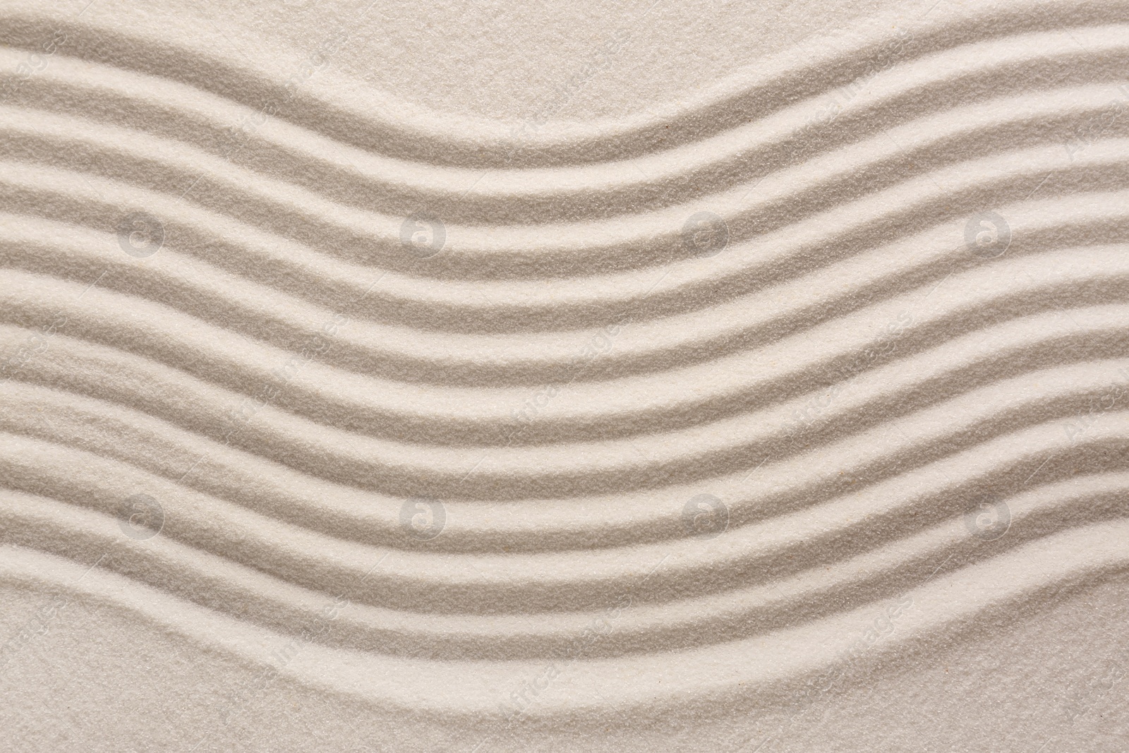 Photo of White sand with pattern as background, top view. Concept of zen and harmony