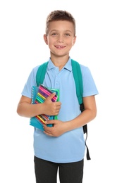 Cute little boy in school uniform with backpack and stationery on white background