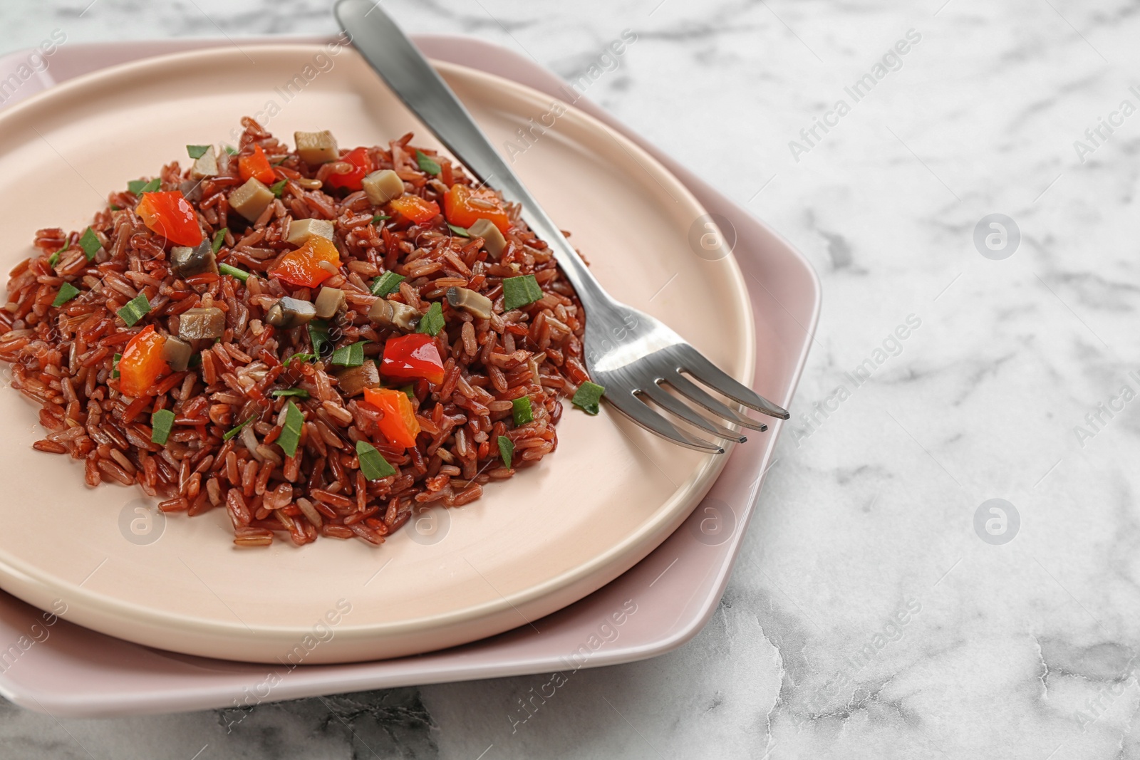 Photo of Tasty brown rice on marble table, closeup